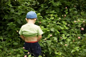 boy urinates outside