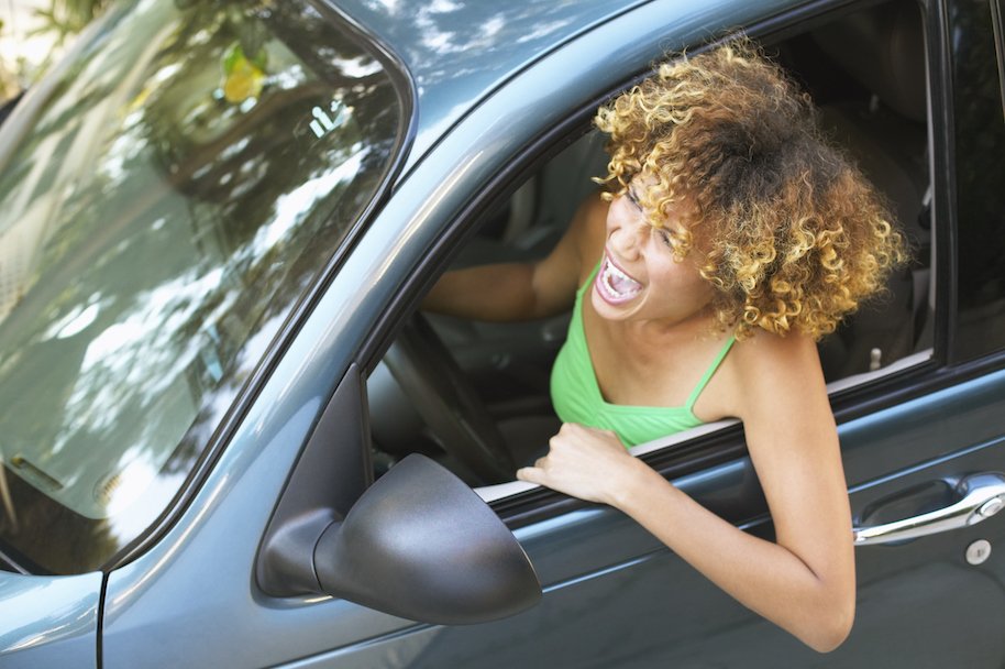 man clings hood speeding car