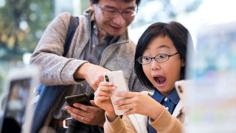 Girl and Dad with Apple iPhone X